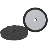 A black disc and a green disk on a green background